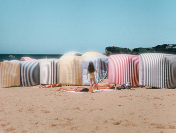  / This photo was taken while I was walking on the beach. I saw this little girl, trying to catch something, I could not say what, but there she was, in the middle of beach tents. She seemed to be free, avoiding her parent's supersvision.