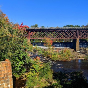 Created by you Beautiful contrast early fall foliage, by a train trestle over the Salmon Falls / Beautiful contrast early fall foliage, by a train trestle over the Salmon Falls River in NH.
