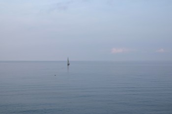 &nbsp; / Calm sea in the evening with sailboat offshore