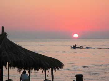 &nbsp; / pink sunset at the beach under the fishermen's hut