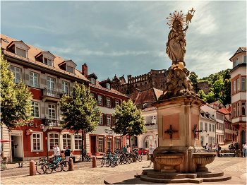 Корнмаркт со статуей Мадонны/Heidelberg, Germany/ / Статуя Мадонны на Корнмаркте была возведена в ходе рекатолизации при курфюрсте Карле Филиппе. Созданная Петером фон ден Бранденом в 1718 году Мадонна на кукурузном рынке считается самой красивой статуей в стиле барокко в Гейдельберге. На западной стороне площади Корнмаркт стоит величественный Дворец принца Карла — с 1788 года гостиница, до 1915 года один из ведущих отелей Гейдельберга, сегодня место проведения мероприятий с великолепным Зеркальным залом, — а в дальнем восточном углу — бледно-желтый дом Французский граф де Граймберг. Шарль де Граймберг по собственной воле и огромными усилиями стал консерватором замка и основателем городских коллекций произведений искусства. Граймберг умер в 1864 году, дожив до своей мечты о сохранении замка.