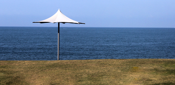 Одинокий зонт / С морем слившийся горизонт
На осеннем , пустынном пляже,
Загрустил одинокий зонт...