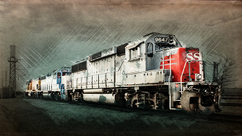 9647 The Red Nosed Engine / Retro style side view of three old diesel locomotive train engines on the tracks, the lead engine with a red nose. Shot from a perspective to convey motion, and processed to give an old fashioned vintage feel to the image. Trains were a huge part of building our nation, and remain a vital part of its infrastructure. Their design and function are pretty timeless, so it is easy to imagine them rolling in from the era of their origin. That's why I usually choose to depict them in a way that gives a nod to their historical origins. From the most early forms of the art, photographers have used various processing equipment and techniques to produce a desired look, and to convey a specific story. These days it is mostly done digitally, but the principal is the same; to craft an image that invokes a desired thought and / or feeling. Hopefully this does just that. Shot in Pryor, Oklahoma. © Rob Heber - All Rights Reserved.