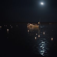 дед мазай / Ганг, Варанаси, ежевечерний обряд-праздник свечей на реке. Лодка с японскими туристами, желающими совершить обряд посреди реки подсвечивается огнями города.