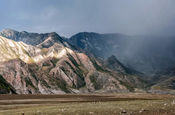 It rains to the right. On the left, the sun highlighted a section of the mountains .... / Осень.... Справа идет дождь. Слева, пробившееся солнце высветило участок гор.... Внизу для понятия масштаба гор, проходит линия телеграфных столбов..