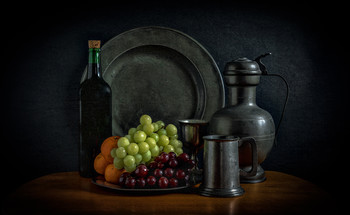 &nbsp; / Still life with some fruit and wine along with pewter plates, jug and cups.