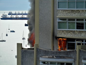 &nbsp; / Vancouver BC Canada, apartment overlooking English Bay, cooking near the patio window shatters the glass and ignites the curtains causing the occupants to flea as the fire spreads.