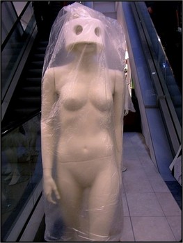 &nbsp; / mannequin wrapped for delivery - artificial light in shop