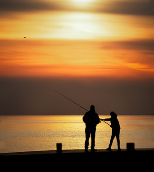 Sunset fishing / Father and son fishing off of a pier at sunset.